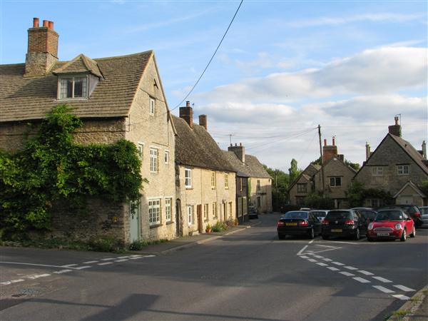 Cotswold stone cottages alongside a road
